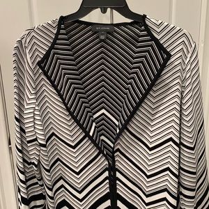 St. John black and white cape with one hook front closure.